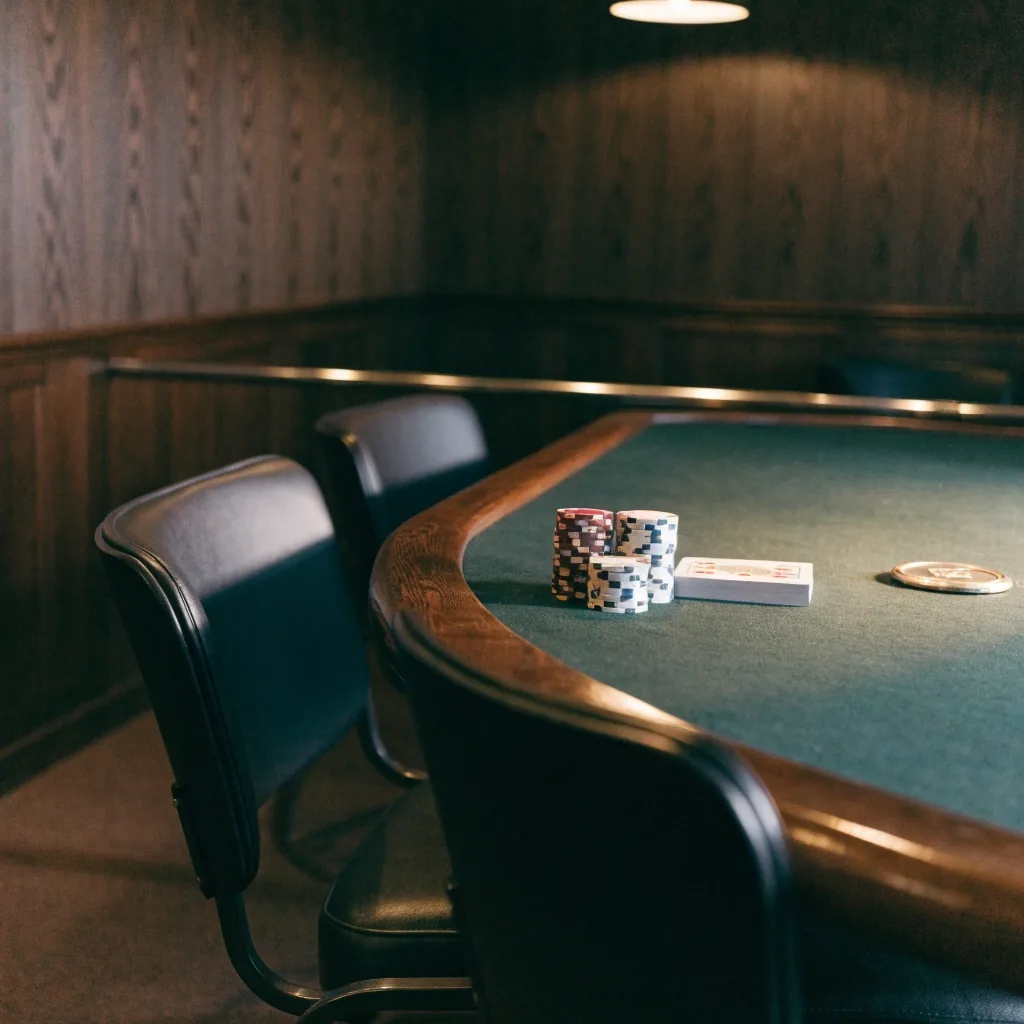 Overhead view of an empty poker table with a closed deck of cards and chip stacks